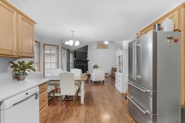 kitchen featuring white dishwasher, light brown cabinets, high end fridge, light countertops, and dark wood-style floors