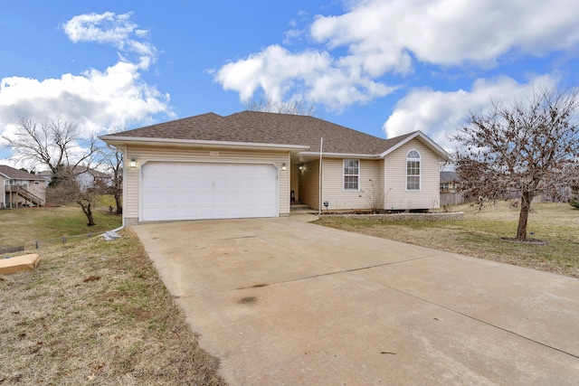 ranch-style house featuring driveway, a shingled roof, an attached garage, and a front yard