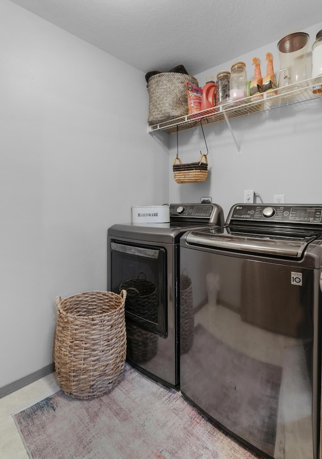 washroom featuring laundry area, independent washer and dryer, and baseboards