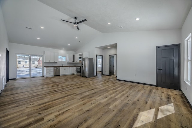 unfurnished living room with a ceiling fan, recessed lighting, visible vents, and light wood-style floors