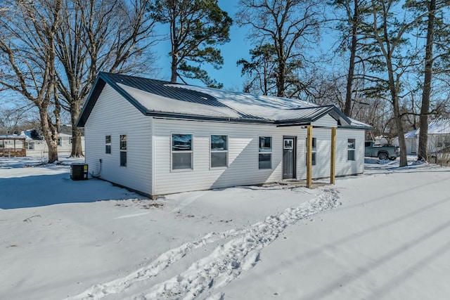 exterior space featuring metal roof and central AC