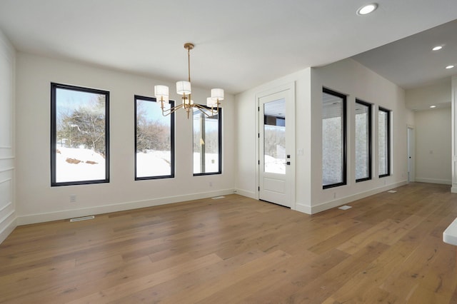 interior space featuring recessed lighting, plenty of natural light, baseboards, and wood finished floors