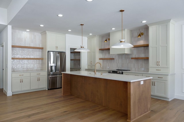 kitchen with decorative light fixtures, stainless steel appliances, light countertops, white cabinetry, and open shelves