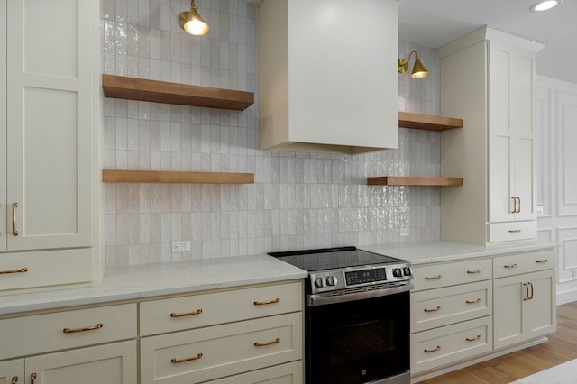 kitchen with light stone countertops, electric range, light wood-type flooring, decorative backsplash, and open shelves