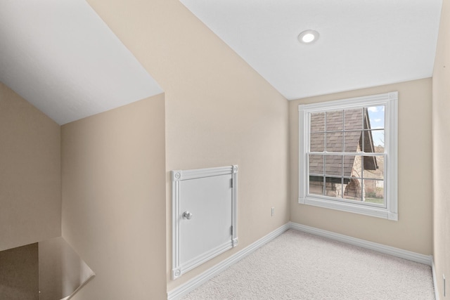 additional living space with carpet, lofted ceiling, and baseboards