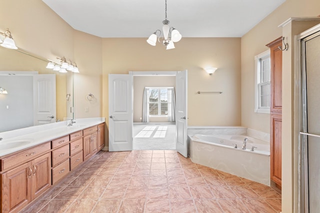 full bathroom with double vanity, a bath, a shower stall, a chandelier, and a sink