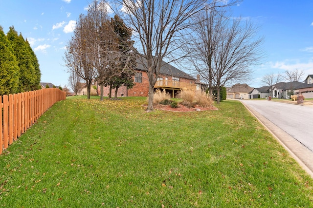 view of yard featuring fence and a residential view