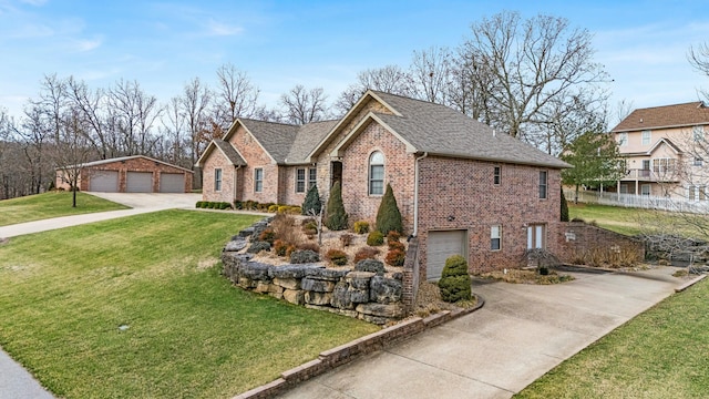 view of front facade with an outbuilding, brick siding, a front lawn, and roof with shingles