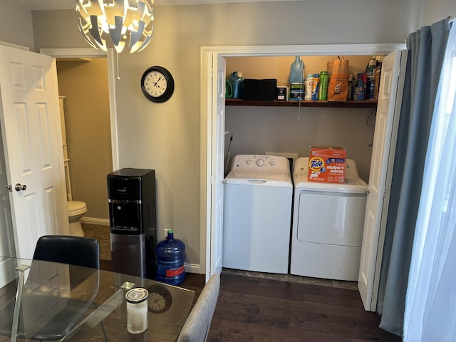 laundry room with dark wood-style floors, laundry area, washing machine and dryer, and baseboards