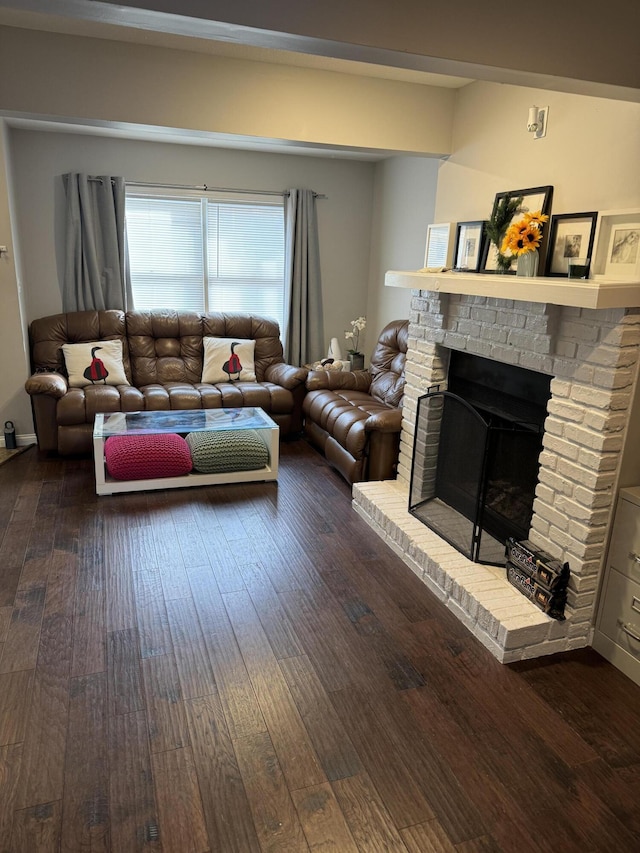 living area featuring dark wood-style floors and a fireplace