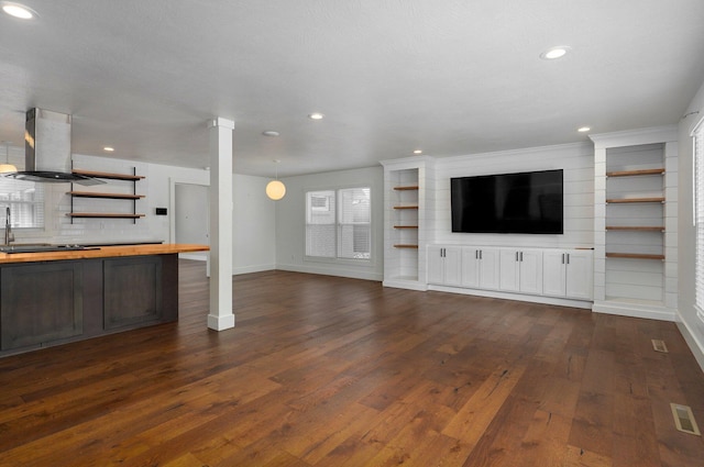 unfurnished living room featuring dark wood-type flooring, recessed lighting, visible vents, and baseboards