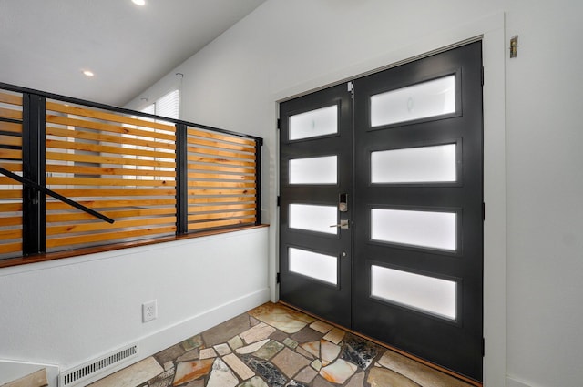 foyer with recessed lighting, stone finish floor, visible vents, and baseboards