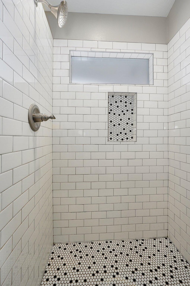 bathroom featuring tiled shower