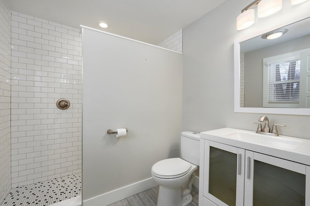 full bath with baseboards, vanity, toilet, and walk in shower