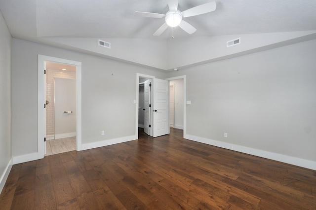 unfurnished bedroom with dark wood-style floors, lofted ceiling, visible vents, and baseboards