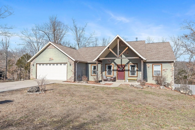 view of front of home featuring driveway, a garage, a shingled roof, covered porch, and a front yard