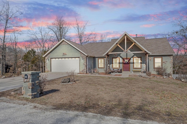 view of front of property with concrete driveway, brick siding, roof with shingles, and an attached garage