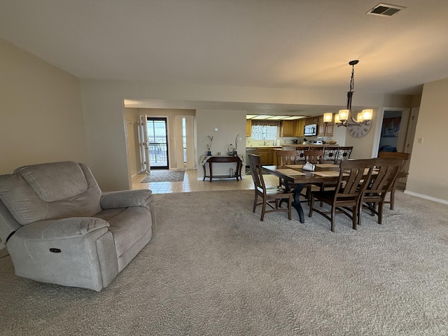 85 La Jolla Dr Unit 352-A, Lake Ozark, MO 65049 - dining space with a chandelier, visible vents, light carpet, and baseboards