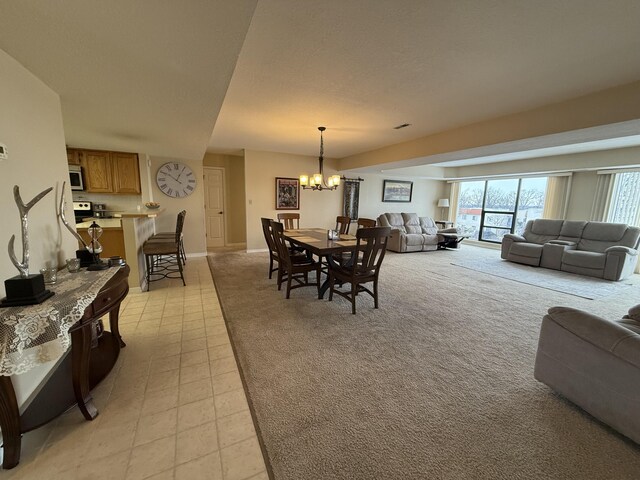 85 La Jolla Dr Unit 352-A, Lake Ozark, MO 65049 - dining space featuring light carpet, baseboards, and an inviting chandelier