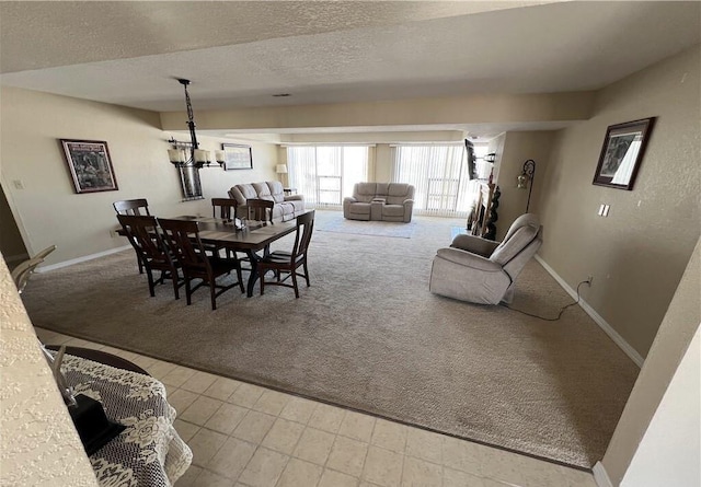 85 La Jolla Dr Unit 352-A, Lake Ozark, MO 65049 - dining room featuring carpet, a textured ceiling, baseboards, and an inviting chandelier