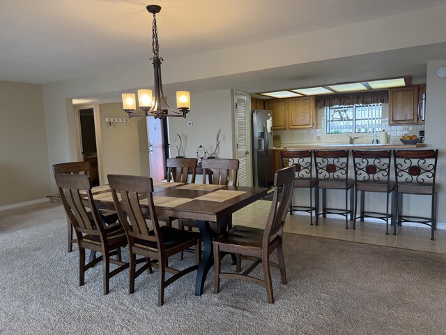 85 La Jolla Dr Unit 352-A, Lake Ozark, MO 65049 - dining area featuring light tile patterned floors, baseboards, and a notable chandelier