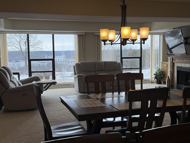 85 La Jolla Dr Unit 352-A, Lake Ozark, MO 65049 - dining room featuring carpet floors, an inviting chandelier, a wealth of natural light, and a tile fireplace