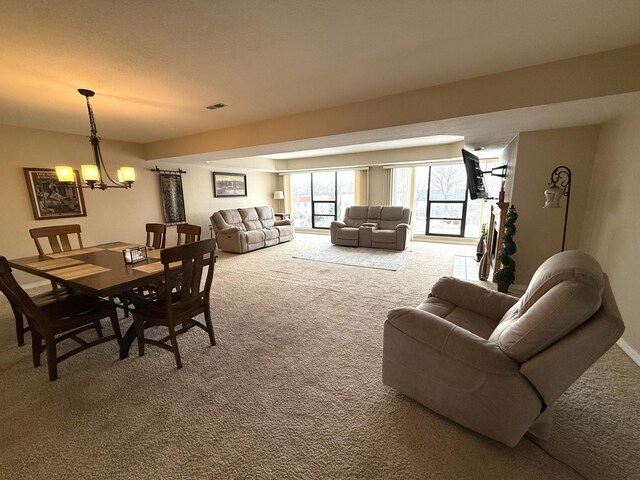 85 La Jolla Dr Unit 352-A, Lake Ozark, MO 65049 - dining area featuring carpet flooring, a notable chandelier, and visible vents