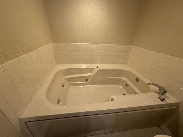 85 La Jolla Dr Unit 352-A, Lake Ozark, MO 65049 - full bathroom with a textured wall and a tub with jets