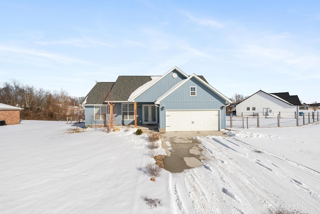 view of front of home with a garage and fence