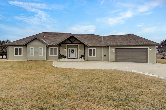 ranch-style home featuring a garage, concrete driveway, and a front yard