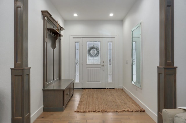 mudroom featuring recessed lighting, light wood-style flooring, and baseboards