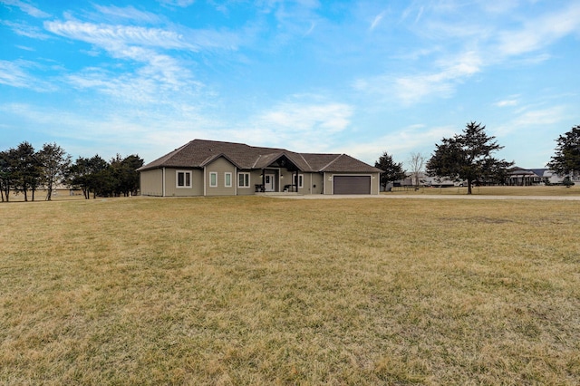 single story home featuring a front yard and an attached garage