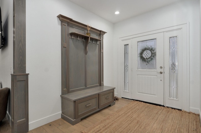 mudroom with recessed lighting, light wood-type flooring, and baseboards