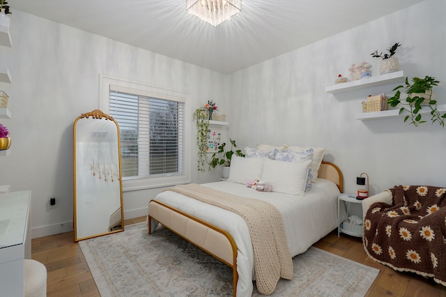 bedroom featuring baseboards and wood finished floors