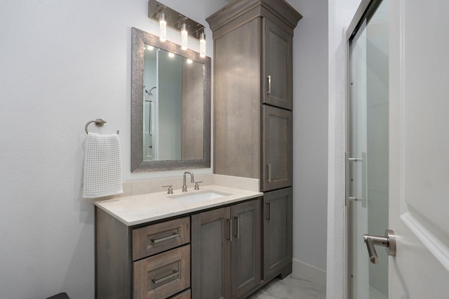 bathroom featuring marble finish floor and vanity