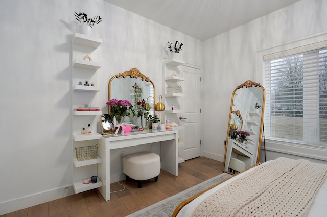 bedroom with baseboards and wood finished floors