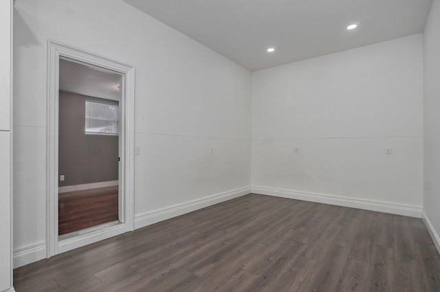 unfurnished room featuring dark wood-style floors, baseboards, and recessed lighting