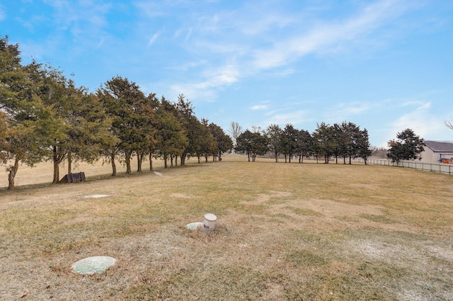 view of yard with a rural view and fence