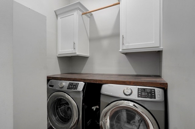 laundry room with cabinet space and washing machine and clothes dryer