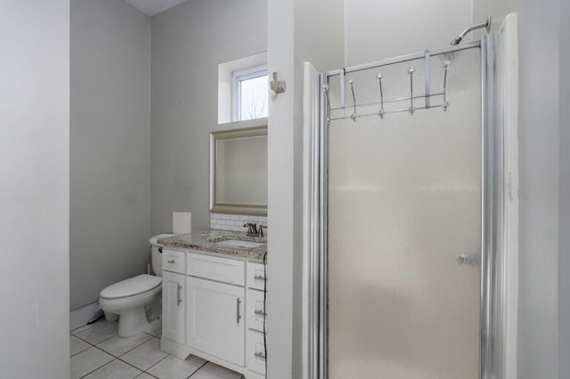 bathroom featuring a stall shower, vanity, toilet, and tile patterned floors