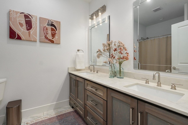 bathroom with marble finish floor, visible vents, baseboards, and a sink