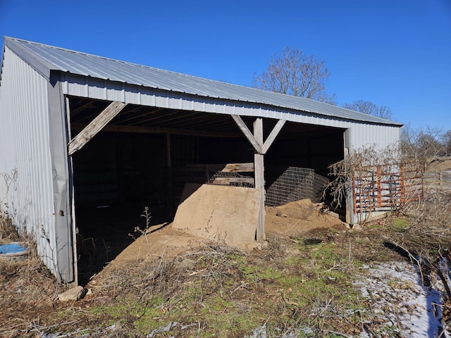 view of outbuilding featuring a carport, an outbuilding, and an exterior structure