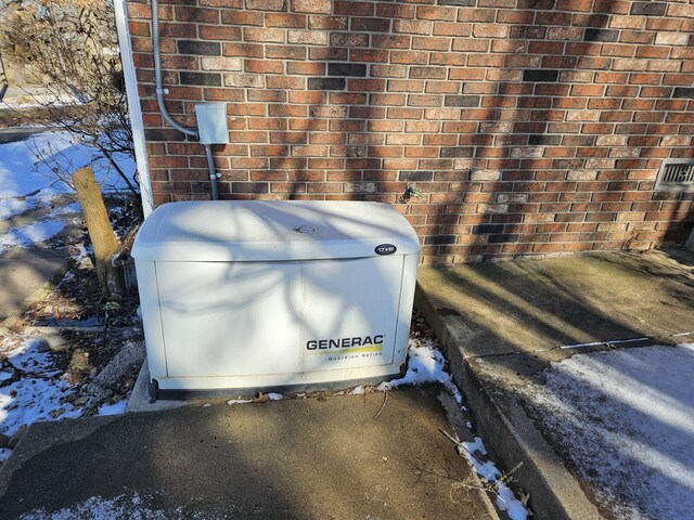 details featuring a power unit and brick siding