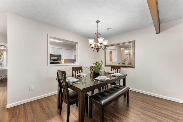 dining room with a textured ceiling, a notable chandelier, baseboards, beam ceiling, and dark wood-style floors