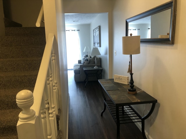 hallway featuring stairs and dark wood finished floors