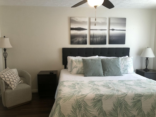 bedroom featuring a textured ceiling, a ceiling fan, and wood finished floors