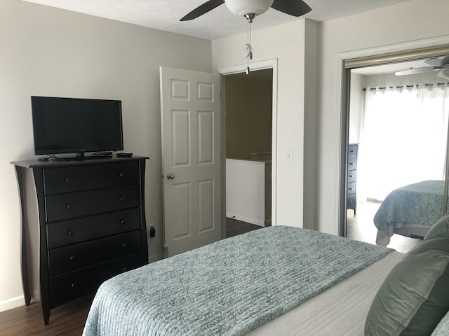 bedroom with dark wood-style floors, baseboards, and a ceiling fan