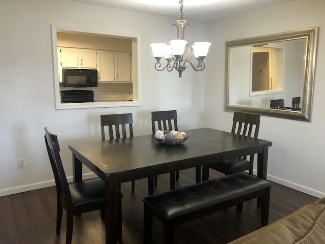 dining room featuring dark wood-type flooring, baseboards, and an inviting chandelier