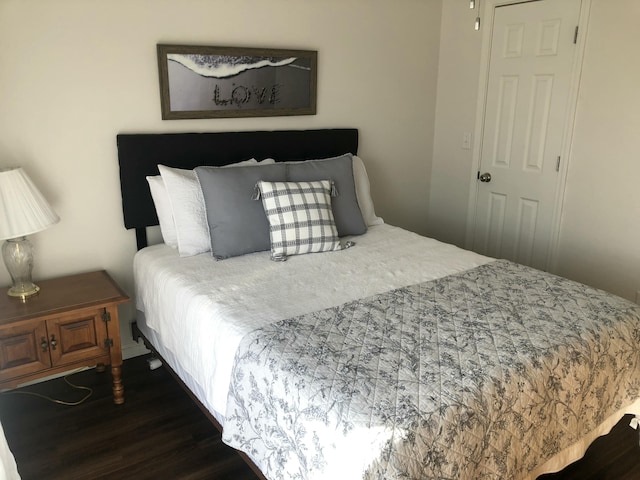 bedroom with dark wood-style flooring