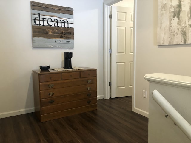 interior space with baseboards and wood finished floors